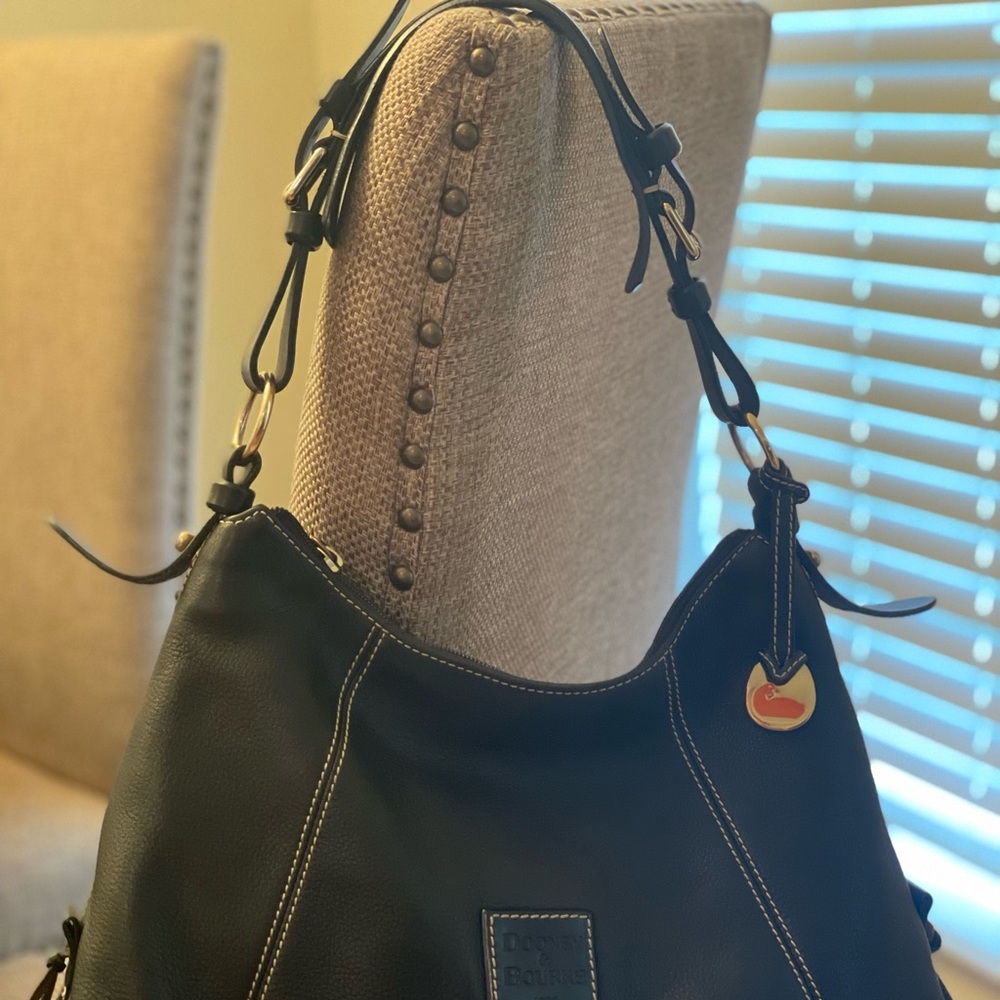 Dooney & Bourke black leather handbag with off white stitching and red lining